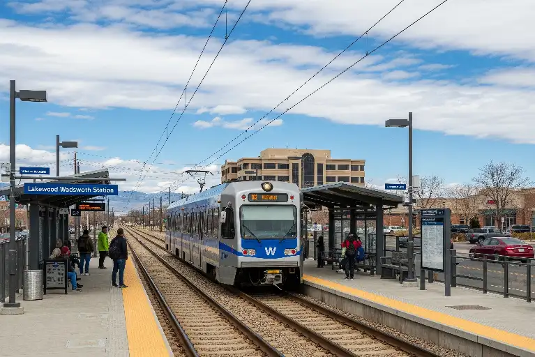 Lakewood Wadsworth RTD light rail station with train arriving, showing easy commute from Lakewood Colorado to downtown Denver